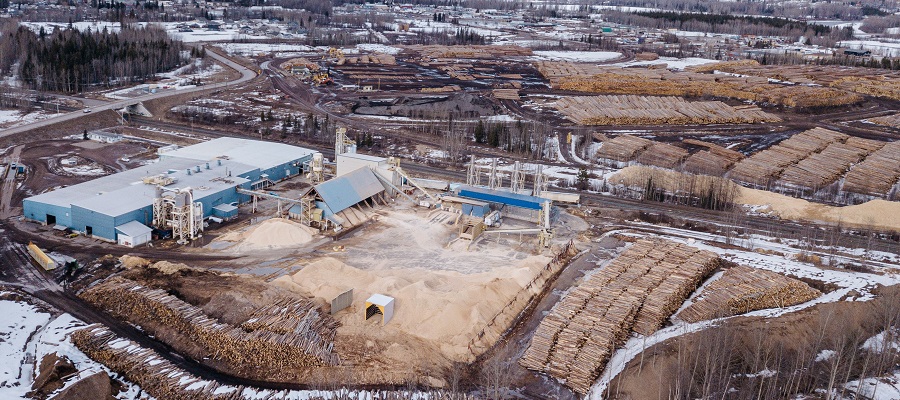 Aerial photo of Smithers mill surrounded by piles of logs