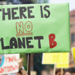 Protest sign reading "THERE IS NO PLANET B"