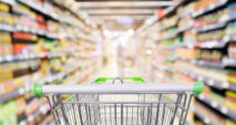 Photo of shopping cart in a grocery store as a part of rising cost of living article.